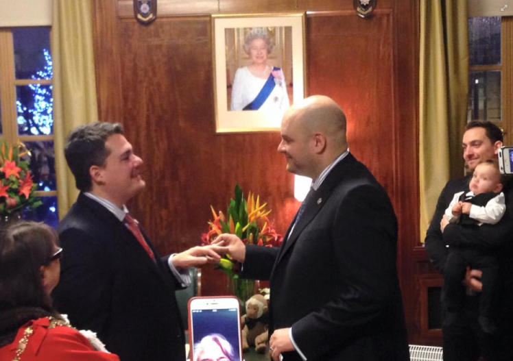 With a portrait of the Queen in the background, the first couple, Philip and Giles,  to marry under Britains new full equality marriage law, take their vows in Judges Chambers.