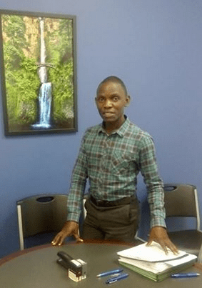 Andrew signing his agency documents