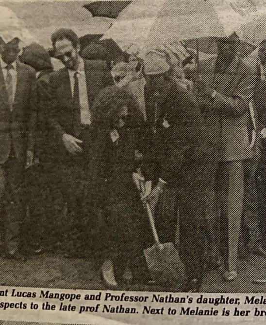 President Mangope helps Carmen Nathan's daughter place the soil in her mother's grave according to some Jewish Tradition, Motswedi Royal Chief Grave yard.